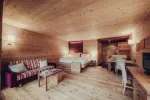 Holzr furnished room with sofa, bed, and wooden furniture