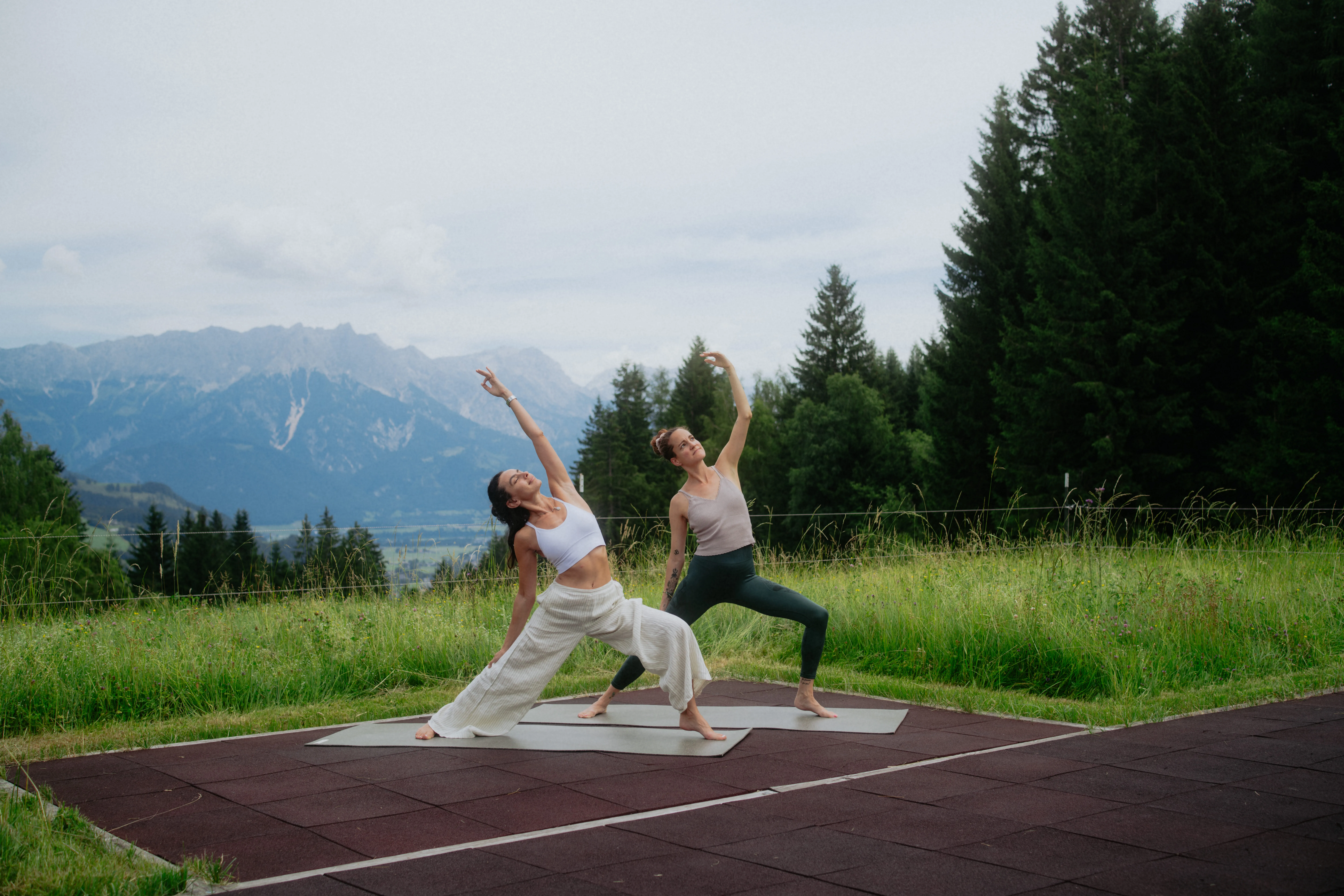 Frauen machen Yoga vor Bergkulisse