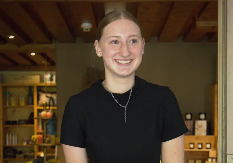 Lächelnde junge Frau in einem Shop-Inneren